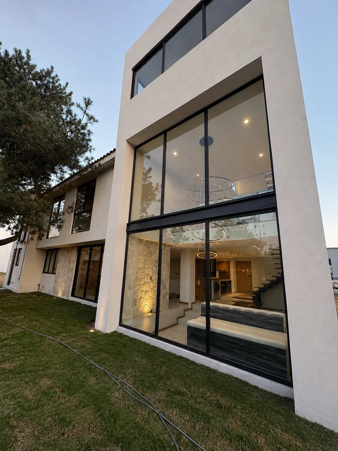 Fachada de cristal y aluminio en volumen residencial de doble altura